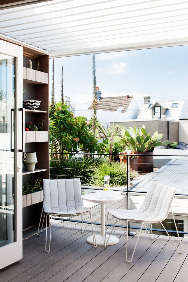 Photo of a small contemporary balcony in Sydney with a pergola.