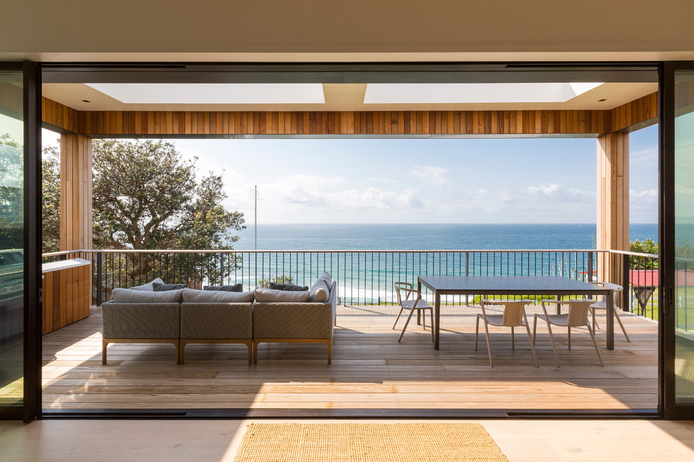 Photo of a large contemporary balcony in Sydney with a pergola.