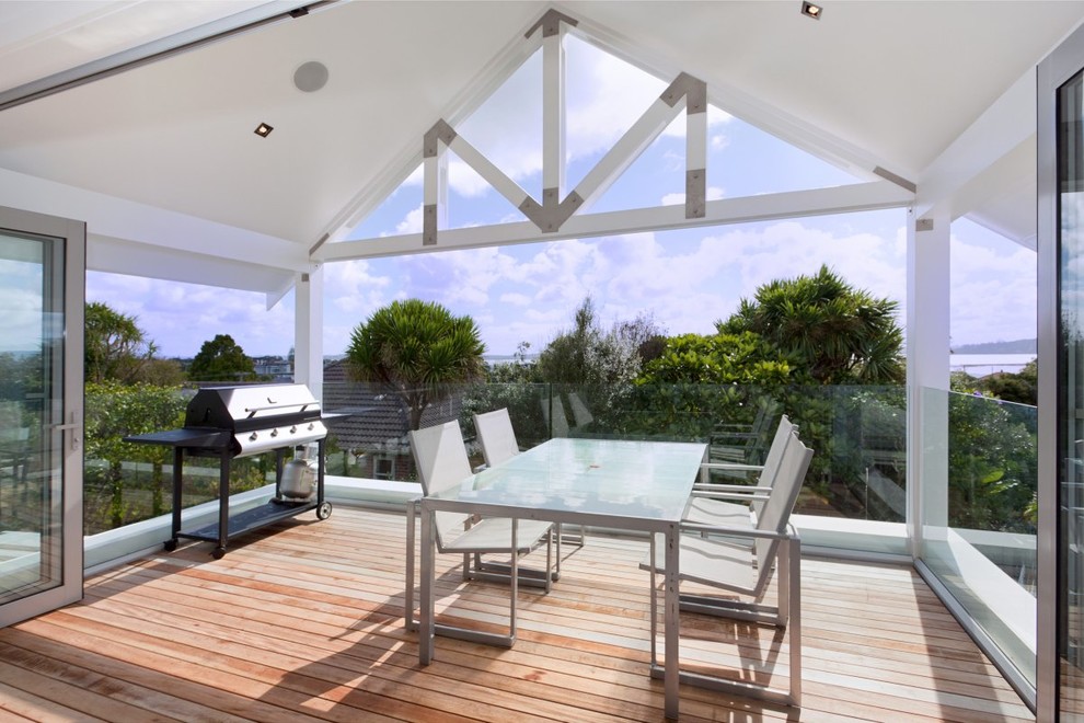 Photo of a medium sized coastal balcony in Auckland with a roof extension.