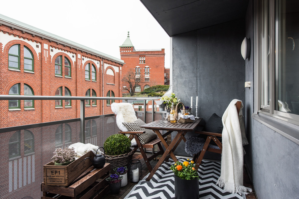 Example of a mid-sized danish balcony design in Gothenburg with an awning