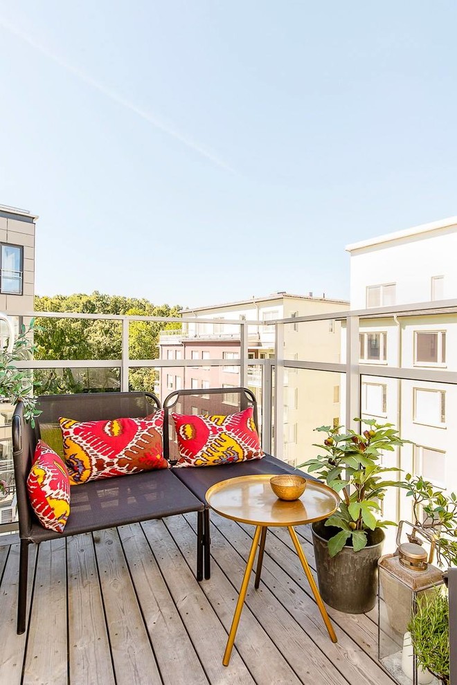 Photo of a small contemporary balcony in Stockholm with a potted garden and no cover.