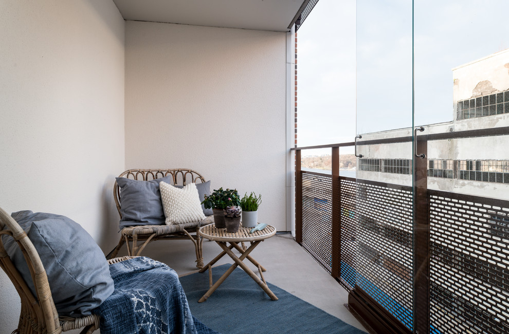 Scandi metal railing balcony in Stockholm with a roof extension.
