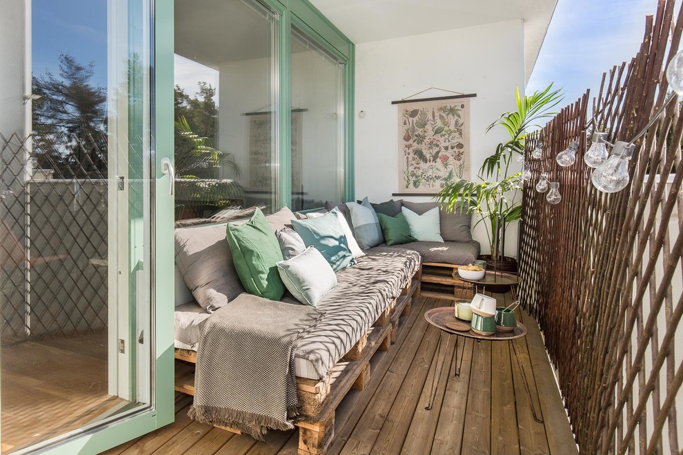 Danish wood railing balcony photo in Stockholm with a roof extension