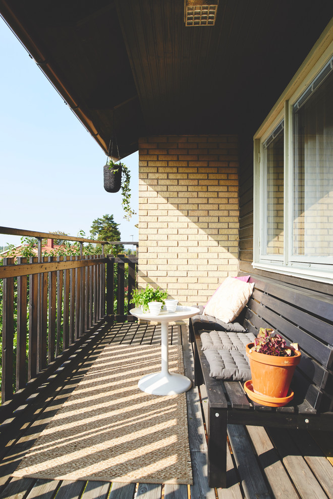 Inspiration for a scandinavian balcony in Other with a roof extension.
