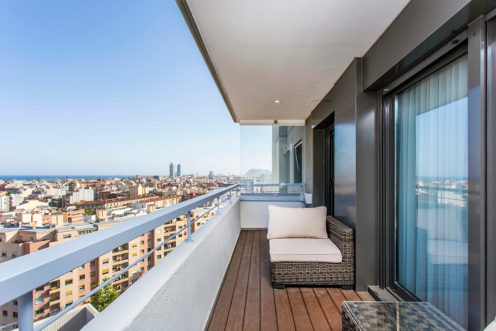 This is an example of a medium sized contemporary balcony in Barcelona with a roof extension.