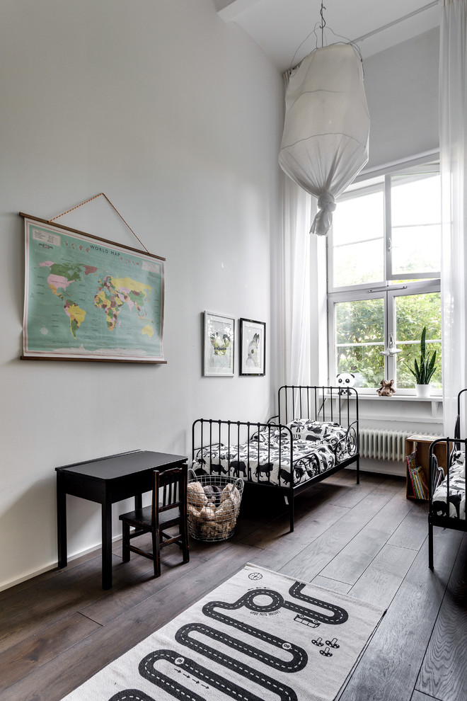 Example of a mid-sized danish boy medium tone wood floor kids' room design in Stockholm with gray walls