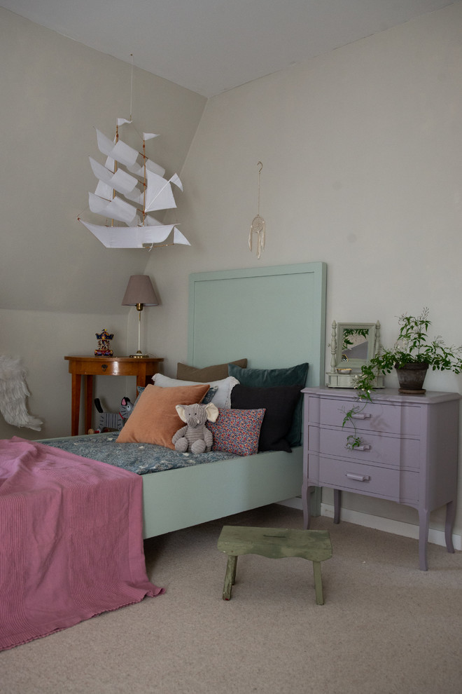 This is an example of a romantic kids' bedroom for girls in Stockholm with beige walls.