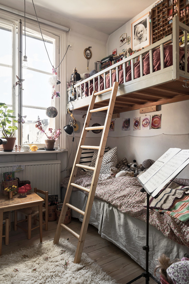 This is an example of a medium sized victorian gender neutral children’s room in Stockholm with white walls.