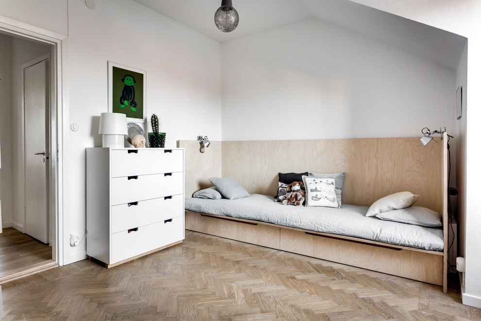 Photo of a large scandinavian gender neutral teen’s room in Stockholm with white walls and light hardwood flooring.