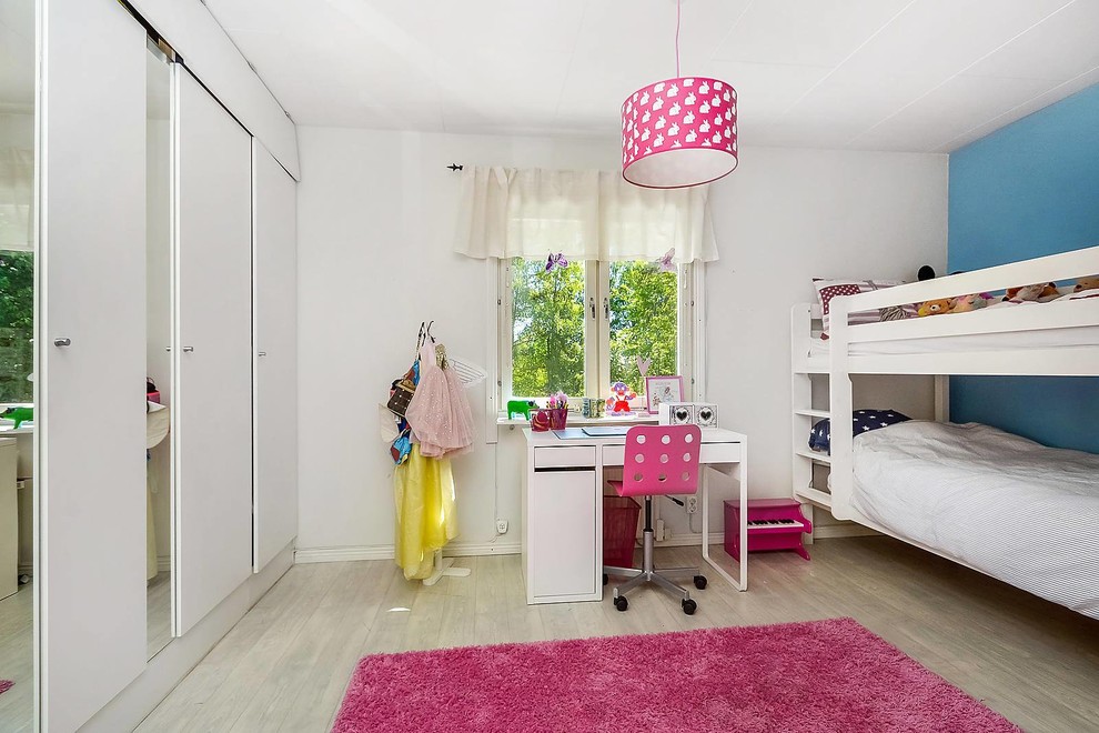 Bild på ett mellanstort minimalistiskt flickrum kombinerat med sovrum och för 4-10-åringar, med vita väggar och ljust trägolv