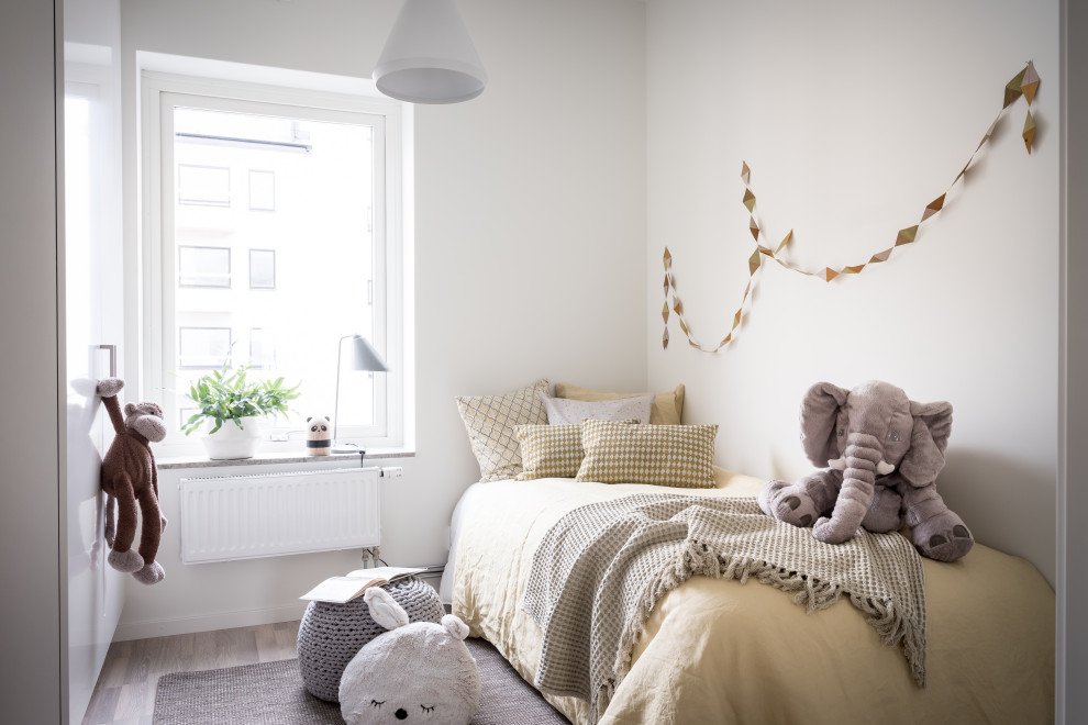 Idéer för skandinaviska könsneutrala barnrum kombinerat med sovrum och för 4-10-åringar, med vita väggar, ljust trägolv och beiget golv