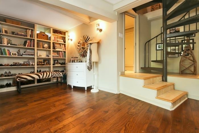 Photo of a medium sized classic walk-out basement in New York with grey walls, dark hardwood flooring and no fireplace.