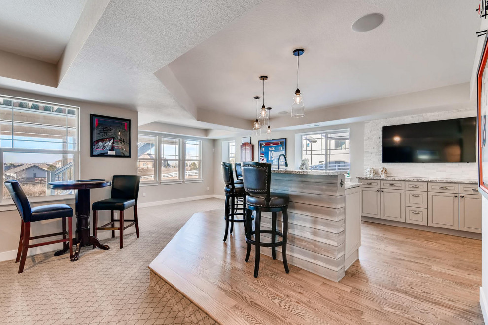 Design ideas for an expansive classic walk-out basement in Denver with a home cinema, grey walls, carpet, multi-coloured floors and a coffered ceiling.