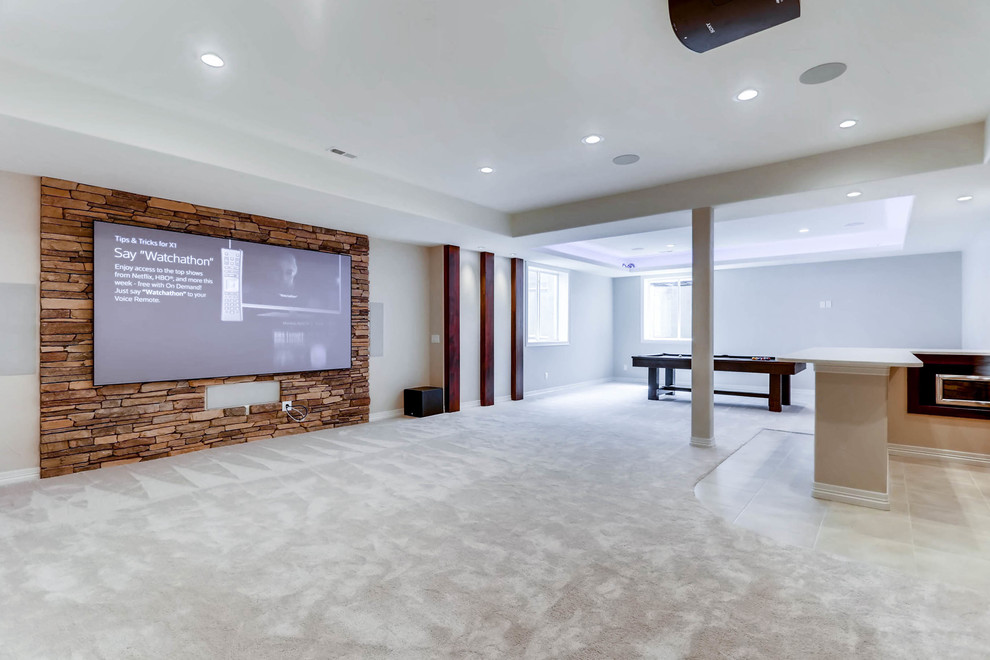 Example of a huge mountain style underground carpeted and white floor basement design in Denver with white walls, a standard fireplace and a stone fireplace