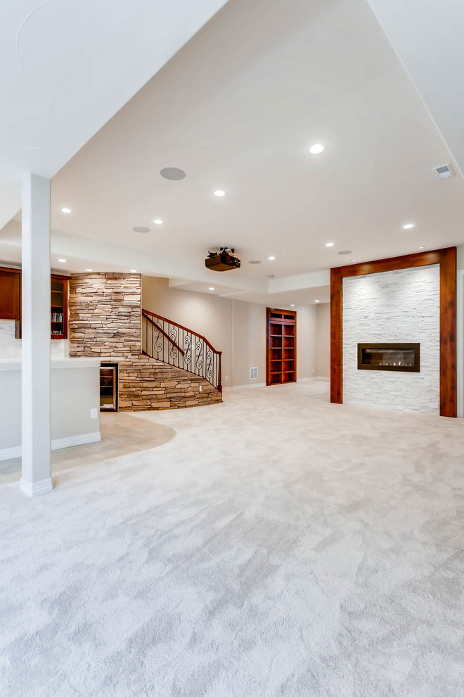 Huge mountain style underground carpeted and white floor basement photo in Denver with white walls, a standard fireplace and a stone fireplace