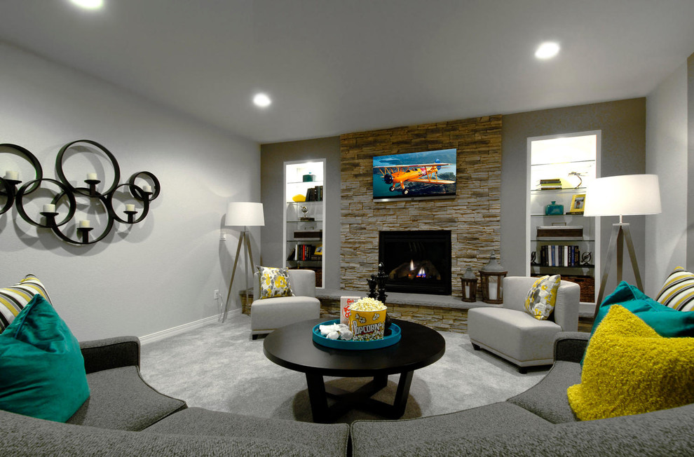 Example of a large trendy walk-out carpeted basement design in Denver with gray walls, a standard fireplace and a stone fireplace