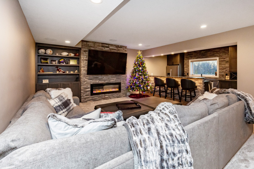 Large transitional look-out carpeted and gray floor basement photo in Other with beige walls, a ribbon fireplace and a stone fireplace