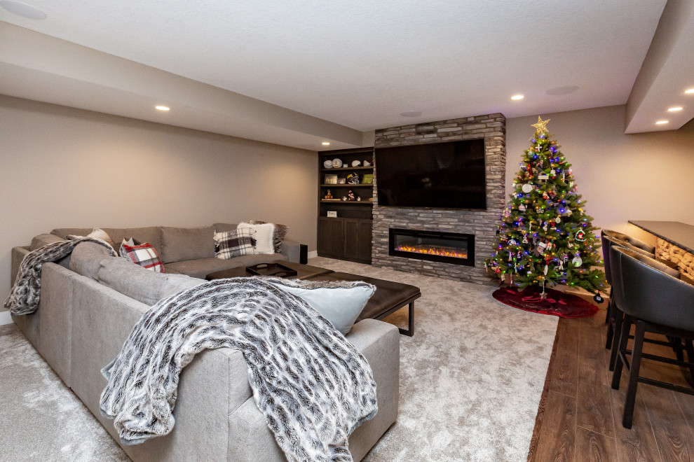 Design ideas for a large classic look-out basement in Other with beige walls, carpet, a ribbon fireplace, a stone fireplace surround and grey floors.