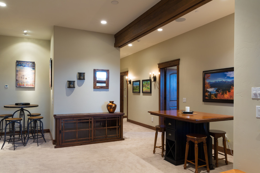 This is an example of a medium sized rustic basement in Denver with white walls, carpet, a standard fireplace, a stone fireplace surround and beige floors.