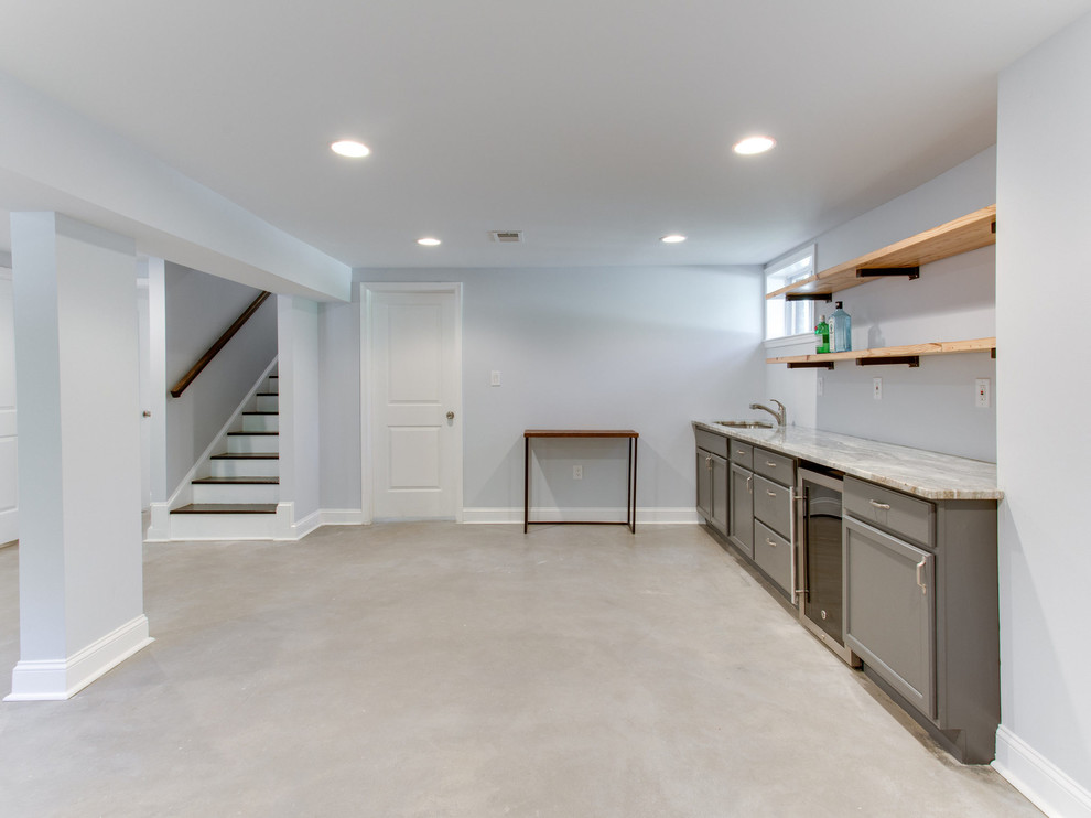 Example of a large minimalist basement design in DC Metro with blue walls