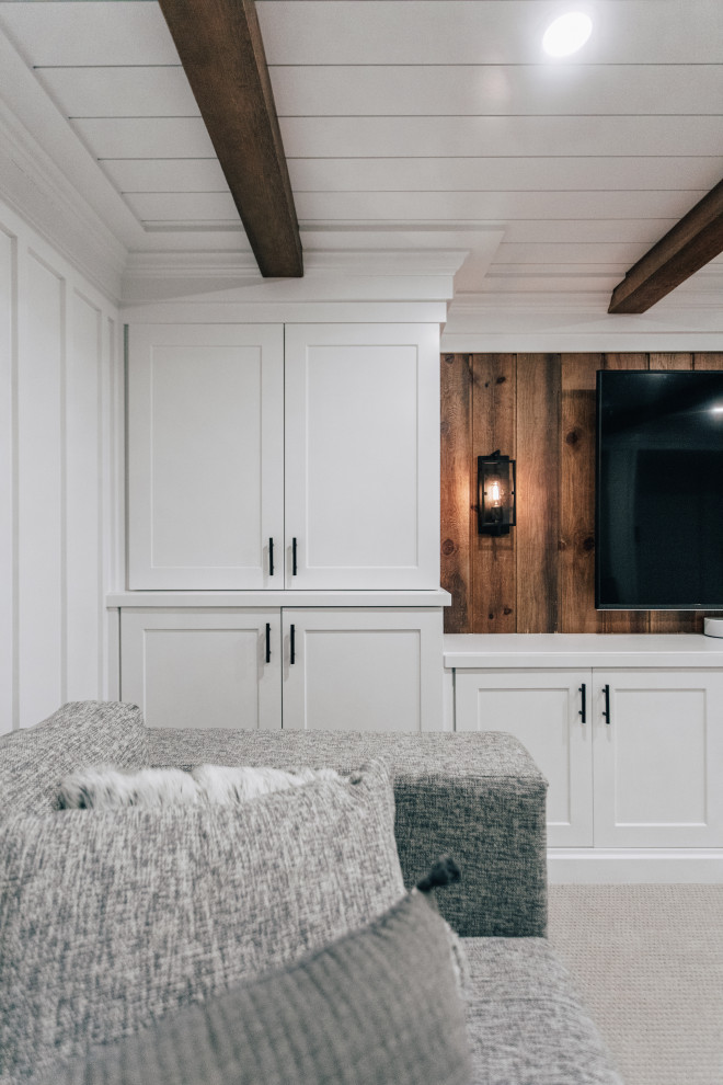 Photo of a medium sized country fully buried basement in Minneapolis with a home bar, white walls, carpet, grey floors, a wood ceiling and panelled walls.