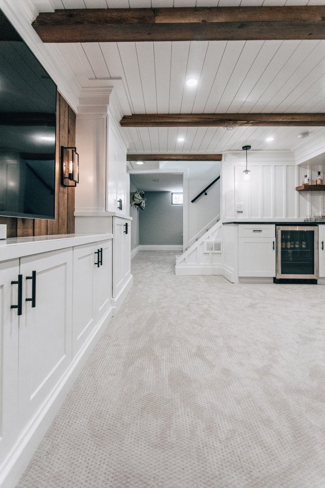 Inspiration for a mid-sized farmhouse underground carpeted, gray floor, wood ceiling and wall paneling basement remodel in Minneapolis with a bar and white walls