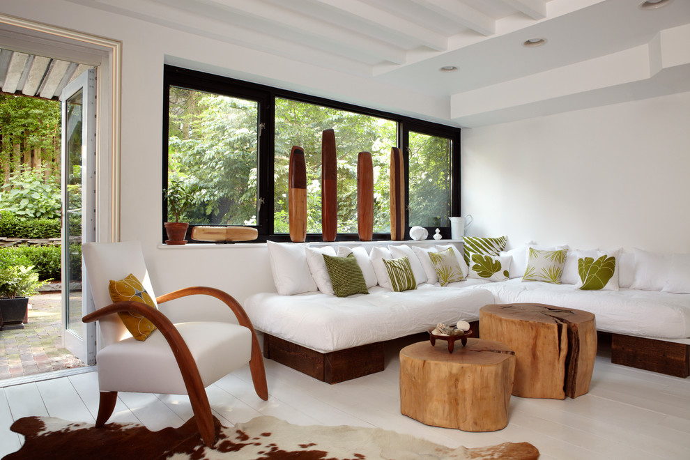 Photo of a medium sized nautical living room in New York with white walls, painted wood flooring, white floors and no fireplace.