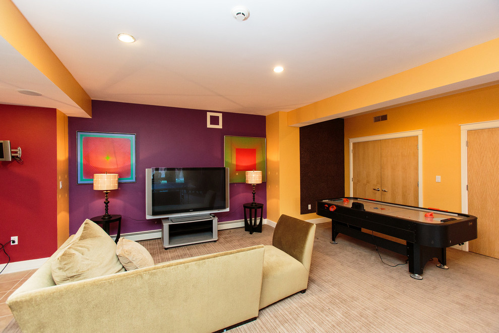 This is an example of an expansive contemporary fully buried basement in Boston with yellow walls and carpet.