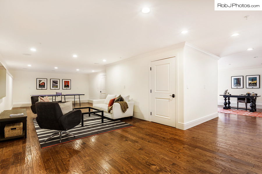 Large tuscan underground medium tone wood floor basement photo in San Francisco with white walls and no fireplace