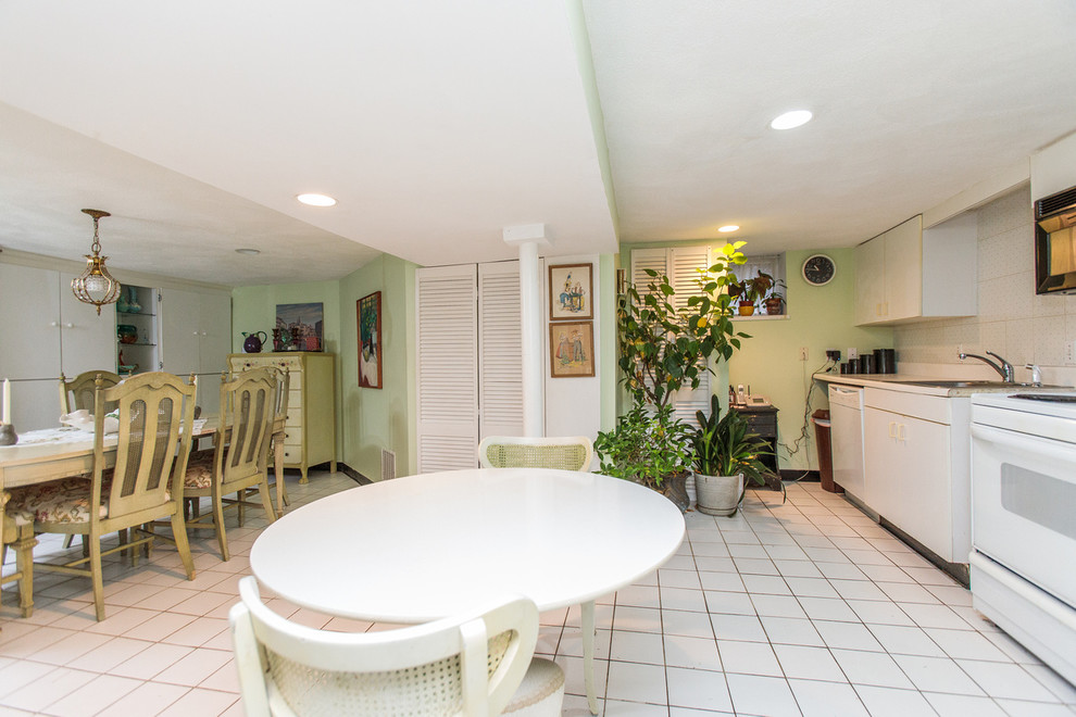 Photo of a large eclectic fully buried basement in Boston with green walls, ceramic flooring and beige floors.