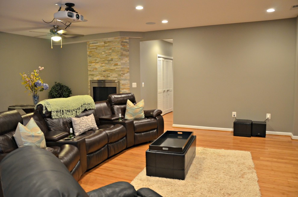 Photo of an expansive traditional look-out basement in DC Metro with grey walls and light hardwood flooring.