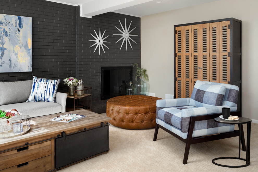 This is an example of a large modern look-out basement in DC Metro with grey walls, carpet, a wood burning stove, a brick fireplace surround and beige floors.