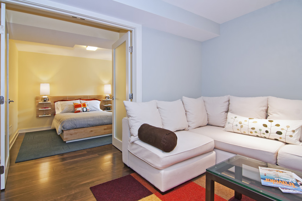 Example of a minimalist basement design in Minneapolis with blue walls
