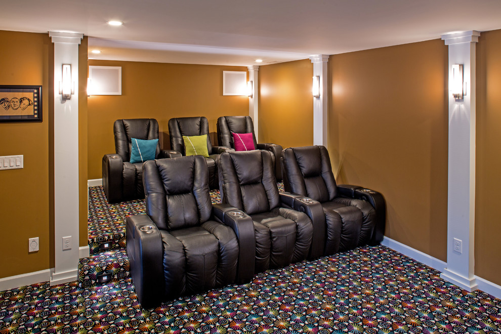 Huge eclectic carpeted home theater photo in St Louis with orange walls