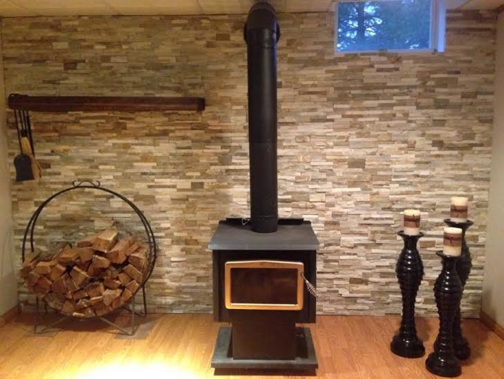Inspiration for a large rustic look-out medium tone wood floor and brown floor basement remodel in Philadelphia with multicolored walls and a wood stove