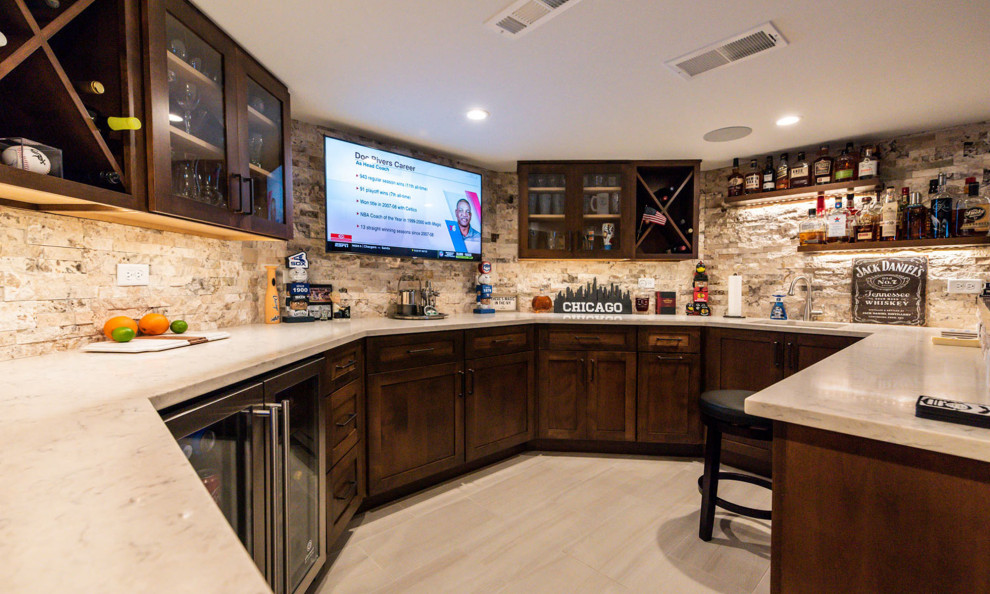 Inspiration for a large traditional fully buried basement in Chicago with a game room, beige walls, medium hardwood flooring, a standard fireplace, a stone fireplace surround and brown floors.