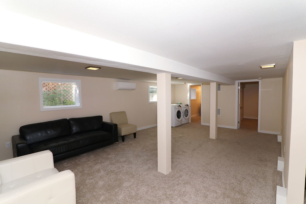 Basement - mid-sized traditional underground carpeted and beige floor basement idea in Portland with beige walls