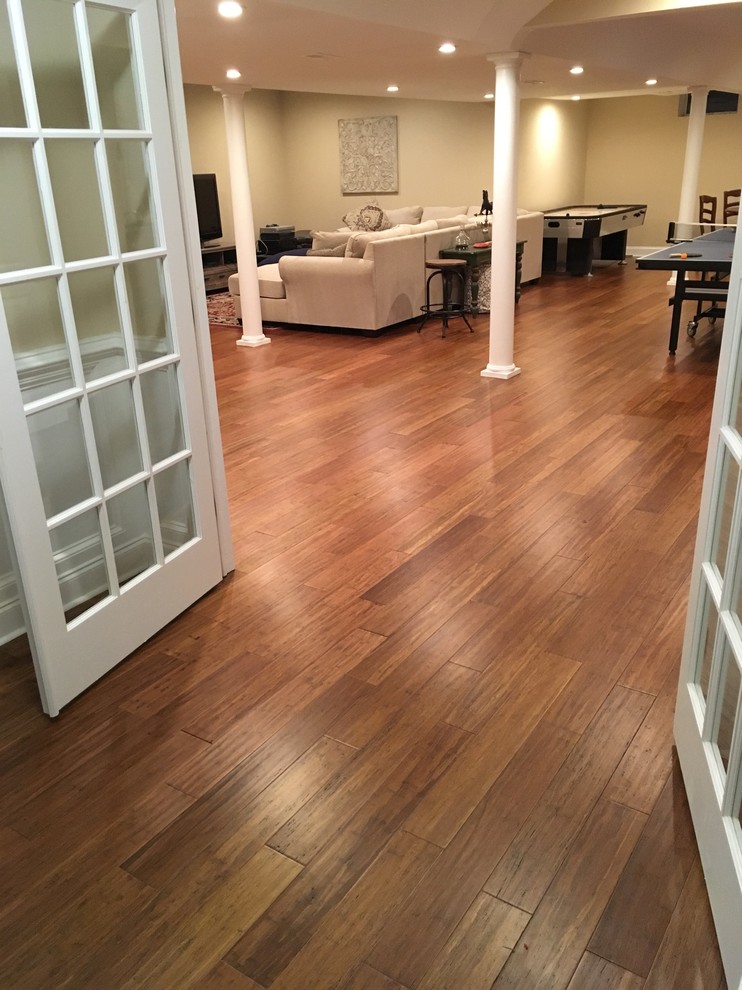 Photo of a bohemian basement in Baltimore with bamboo flooring and brown floors.