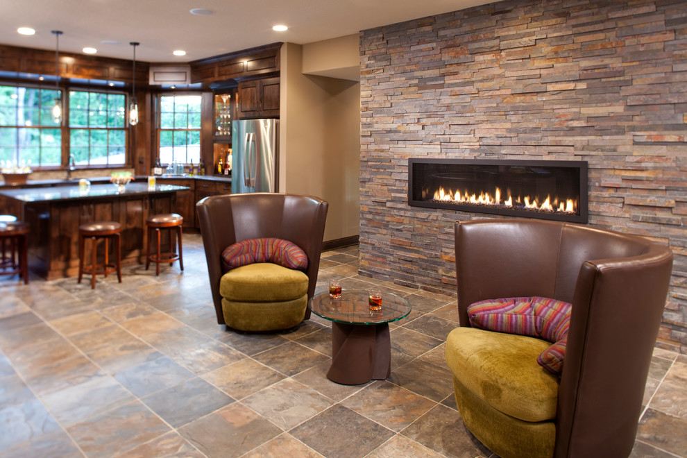 This is an example of a large traditional walk-out basement in Minneapolis with beige walls, carpet, a ribbon fireplace, a stone fireplace surround and multi-coloured floors.