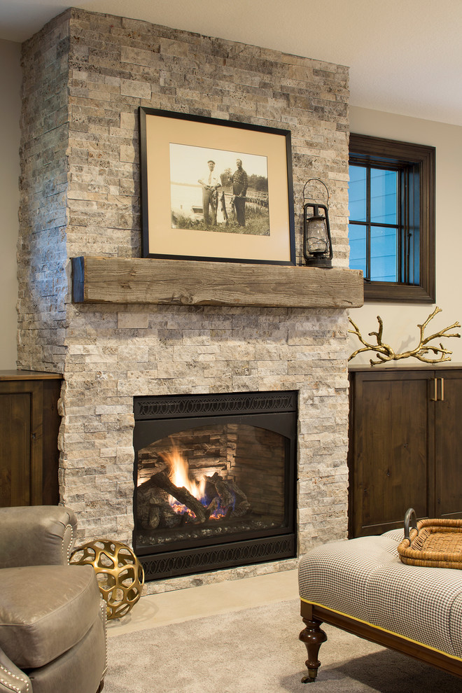 Inspiration for a coastal carpeted basement remodel in Minneapolis with beige walls, a standard fireplace and a stone fireplace