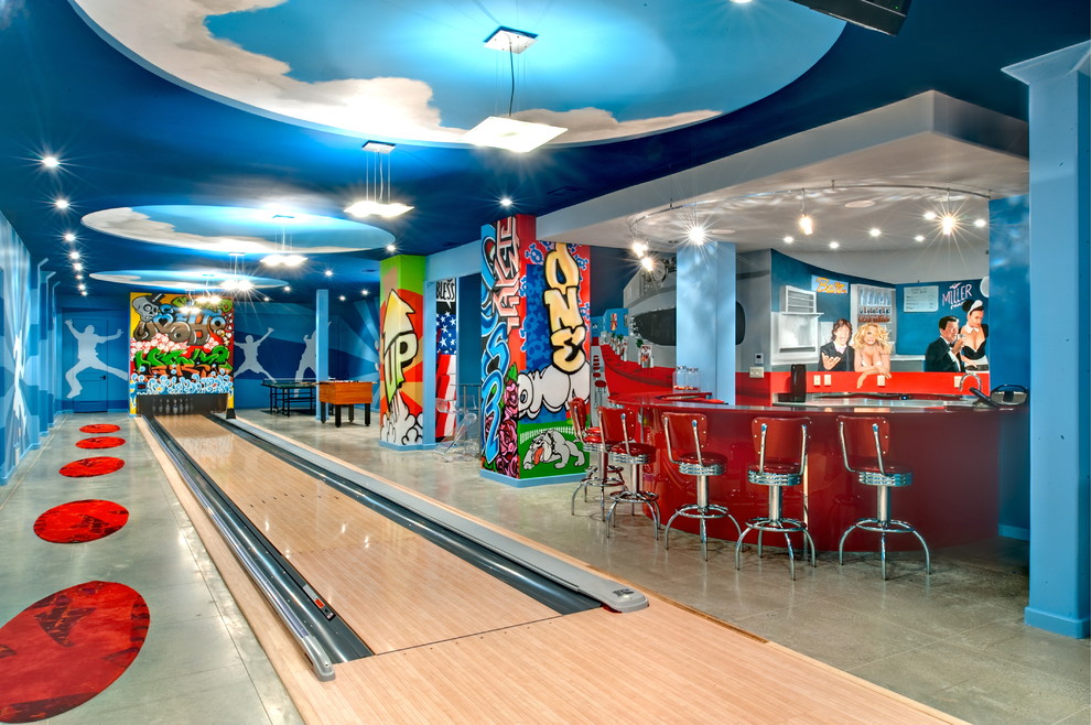 Trendy underground concrete floor basement game room photo in Atlanta with blue walls and no fireplace