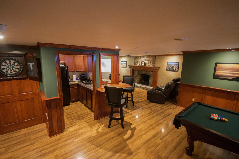 Medium sized classic fully buried basement in Baltimore with green walls, light hardwood flooring and no fireplace.