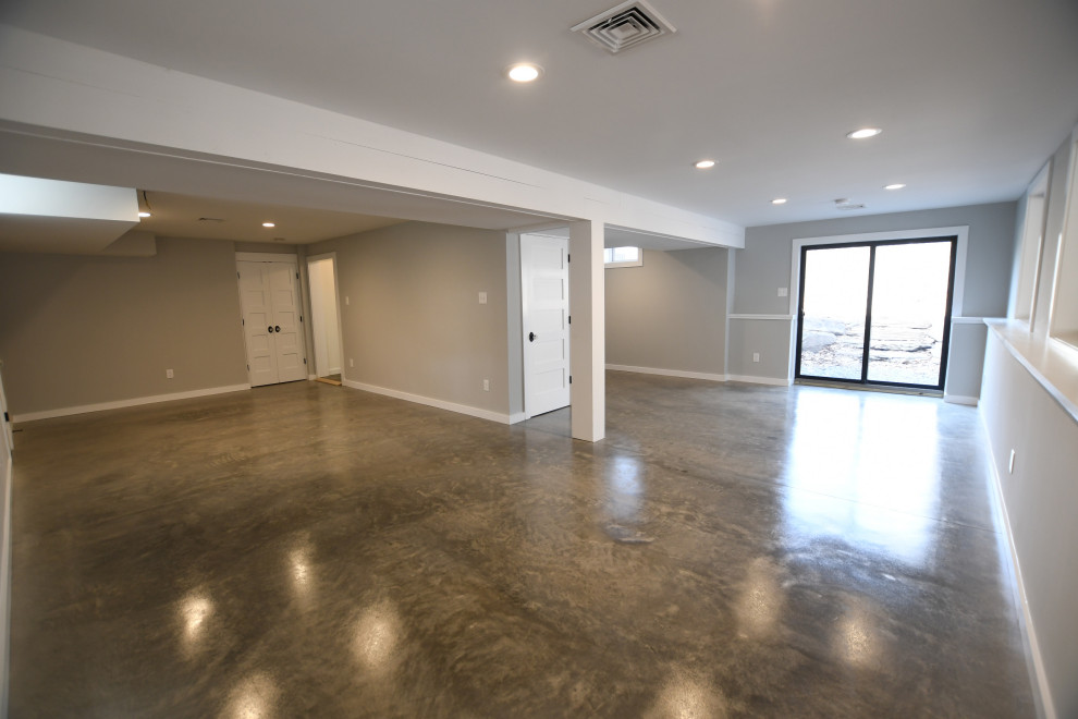 Inspiration for a large country walk-out basement in New York with grey walls, concrete flooring and grey floors.