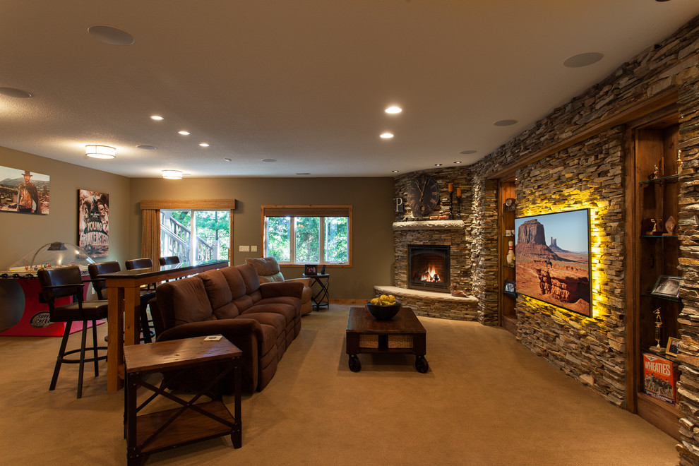 Example of a large walk-out carpeted basement design in Minneapolis with beige walls, a standard fireplace and a stone fireplace