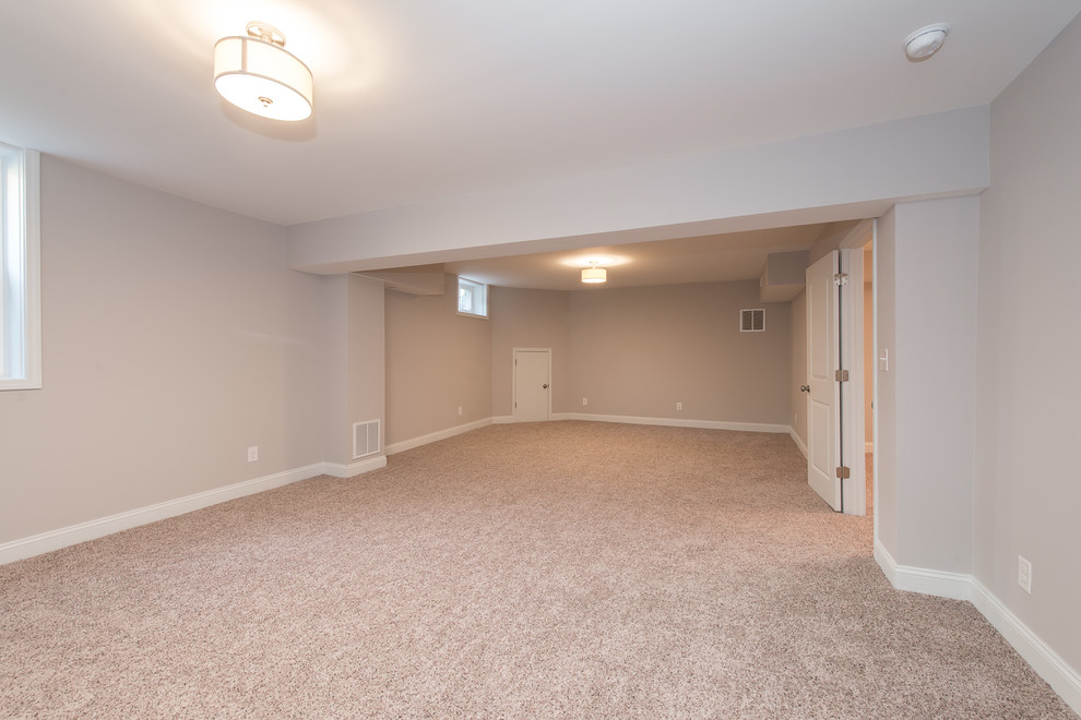 Large arts and crafts carpeted and beige floor basement photo in Charlotte with gray walls
