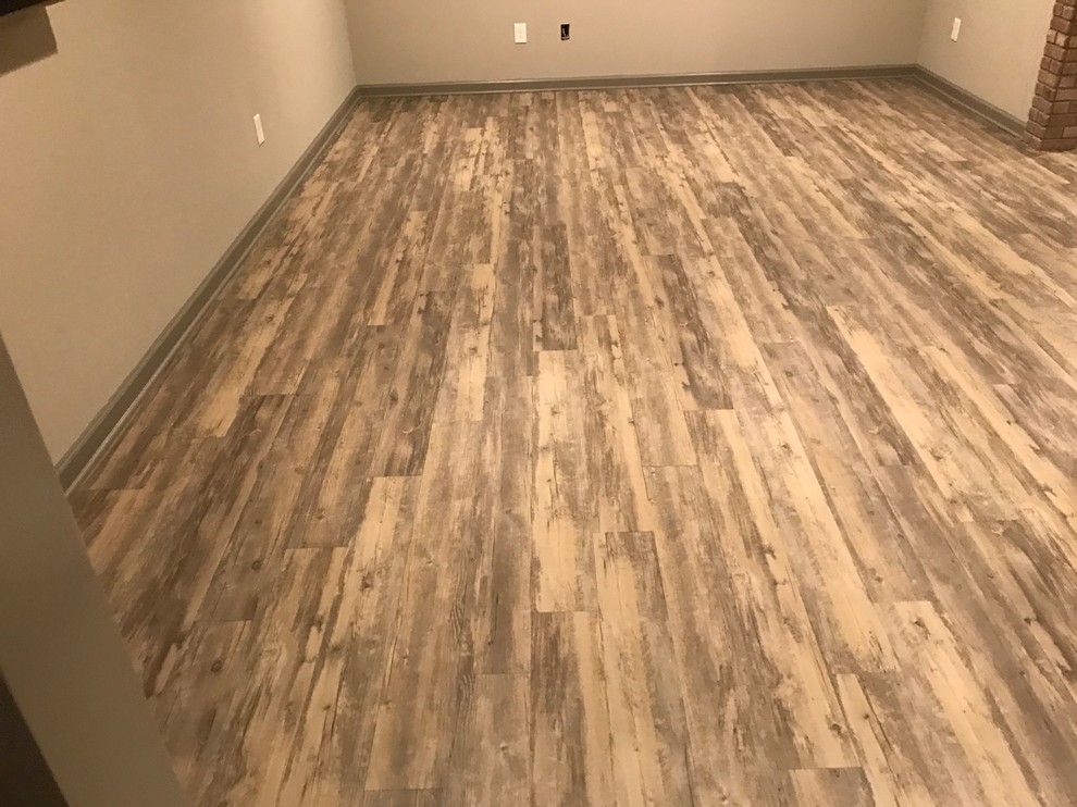 Example of a large urban light wood floor basement design in Atlanta with white walls and no fireplace