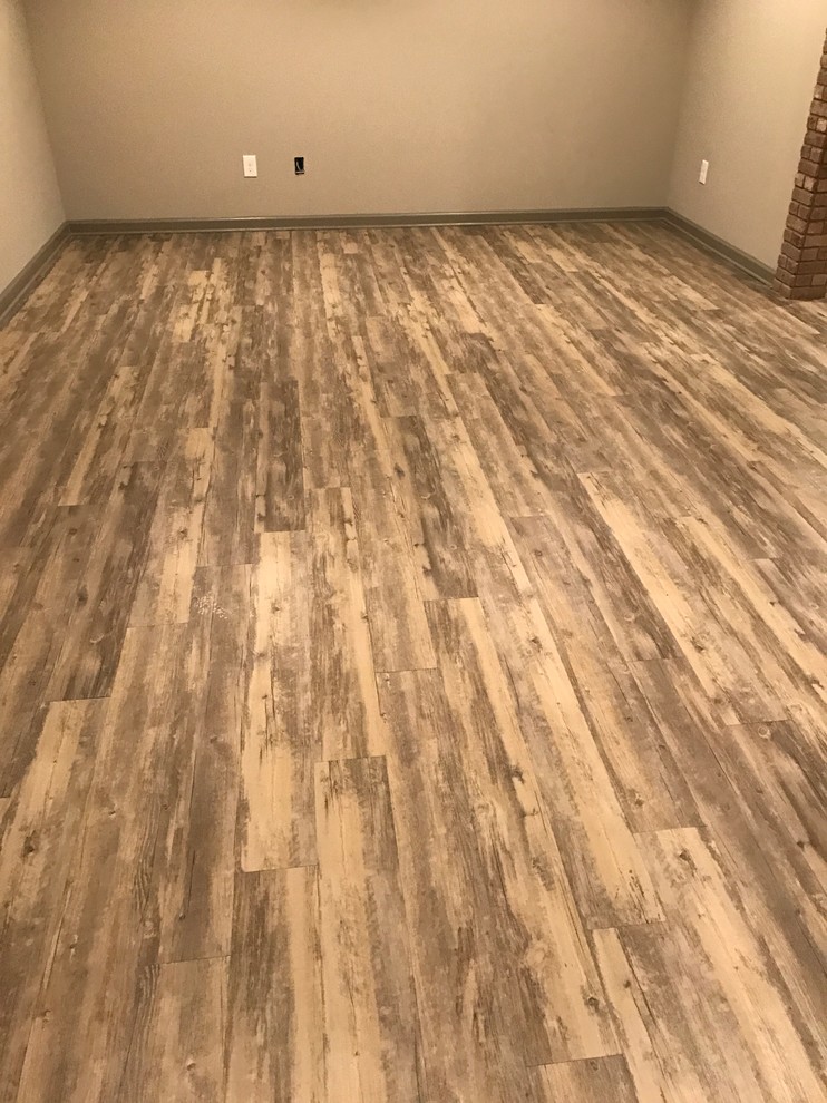 Example of a large urban light wood floor basement design in Atlanta with white walls and no fireplace