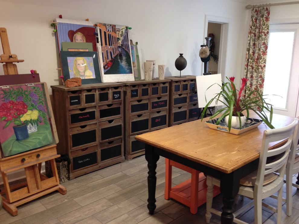 Example of a transitional walk-out ceramic tile basement design in Other with white walls