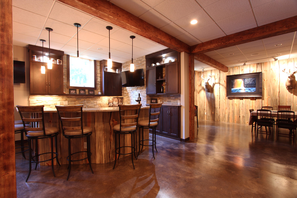 Example of a mountain style look-out concrete floor basement design in Other with beige walls