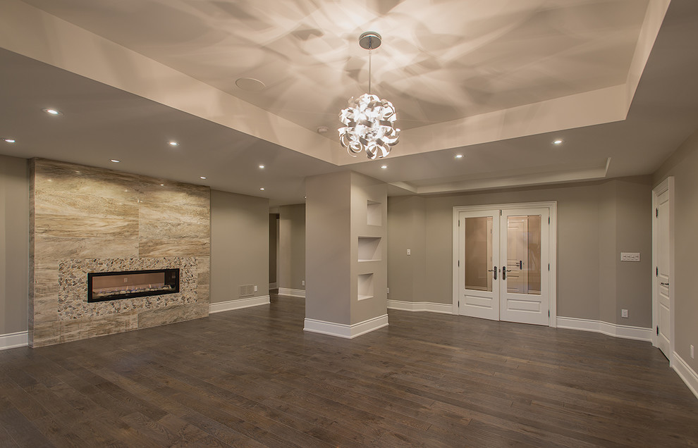 Inspiration for a timeless basement remodel in Toronto with gray walls and a ribbon fireplace